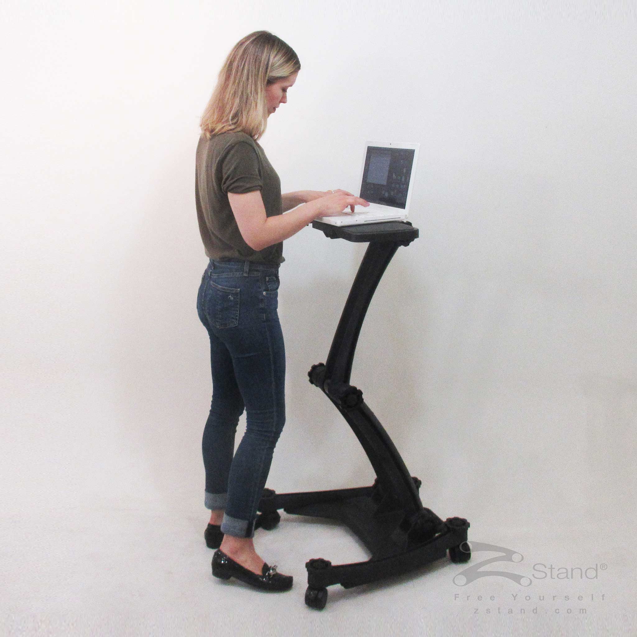 Image of a woman standing and doing work on her laptop thanks to the ZStand Sportster LT portable workstation
